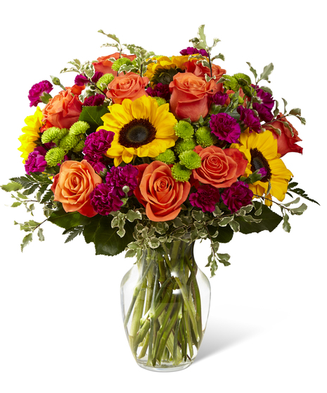The Color Craze Bouquet features sunflowers and orange roses with
