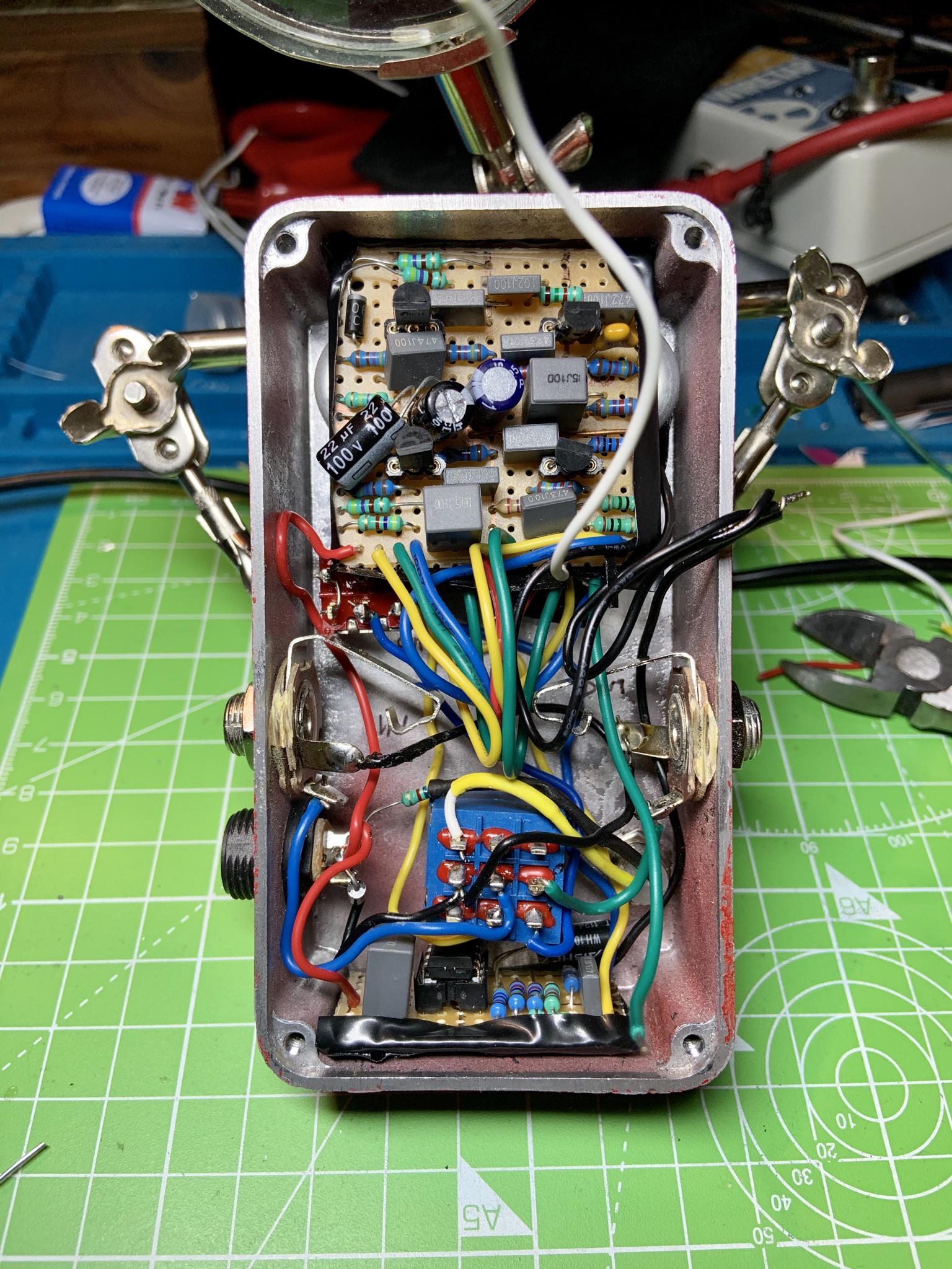 Final steps of a Mad Professor Ruby Red Booster Build. Stuffing