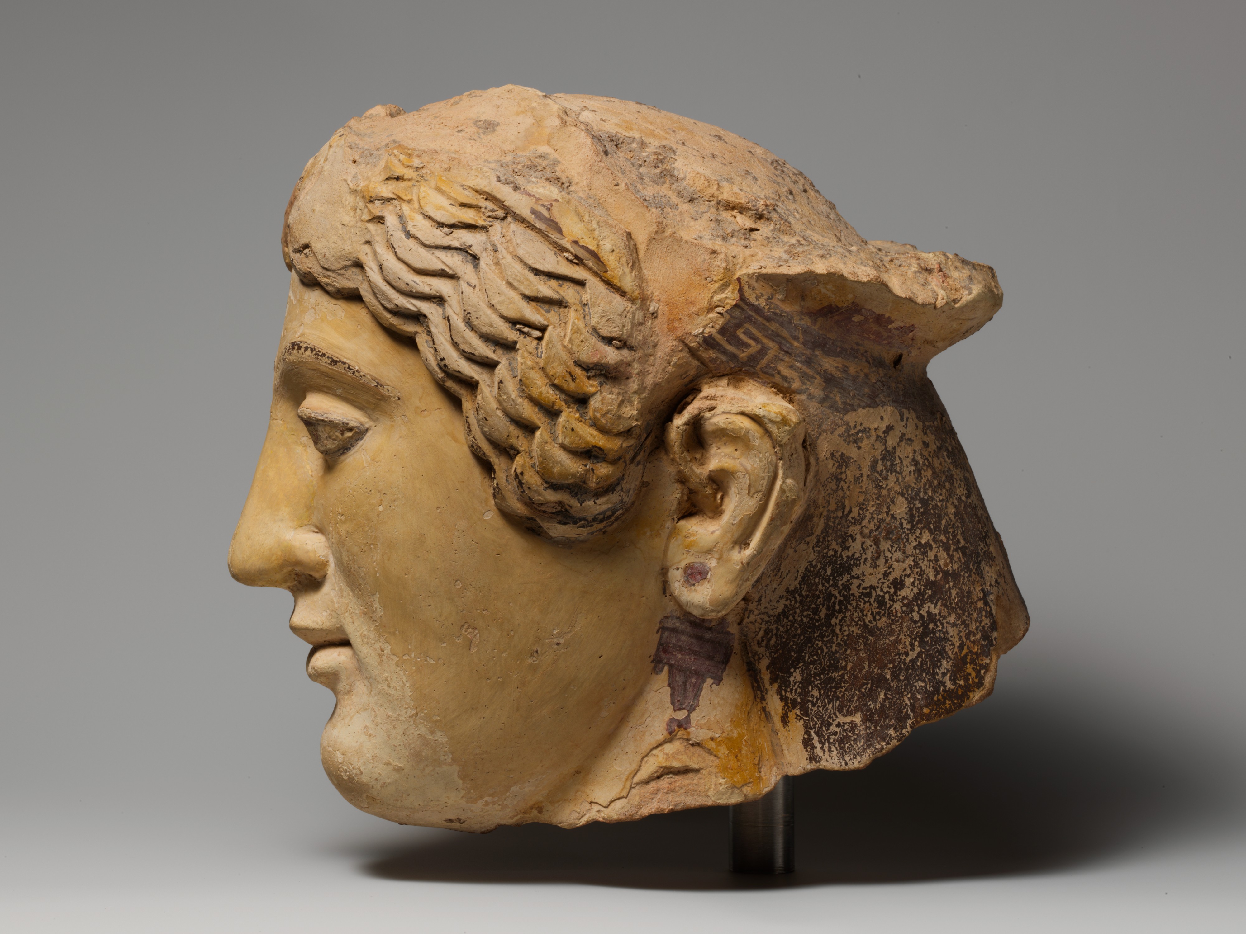 Terracotta head of a woman, probably a sphinx - Greek - Archaic